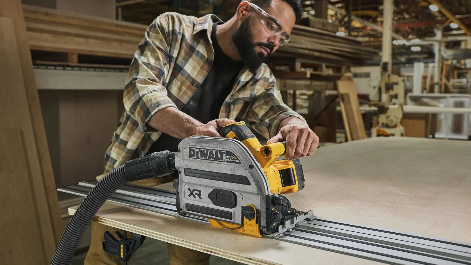 Ein Mann sägt mit der 18 V Akku-Tauchkreissäge von Dewalt ein Brett.