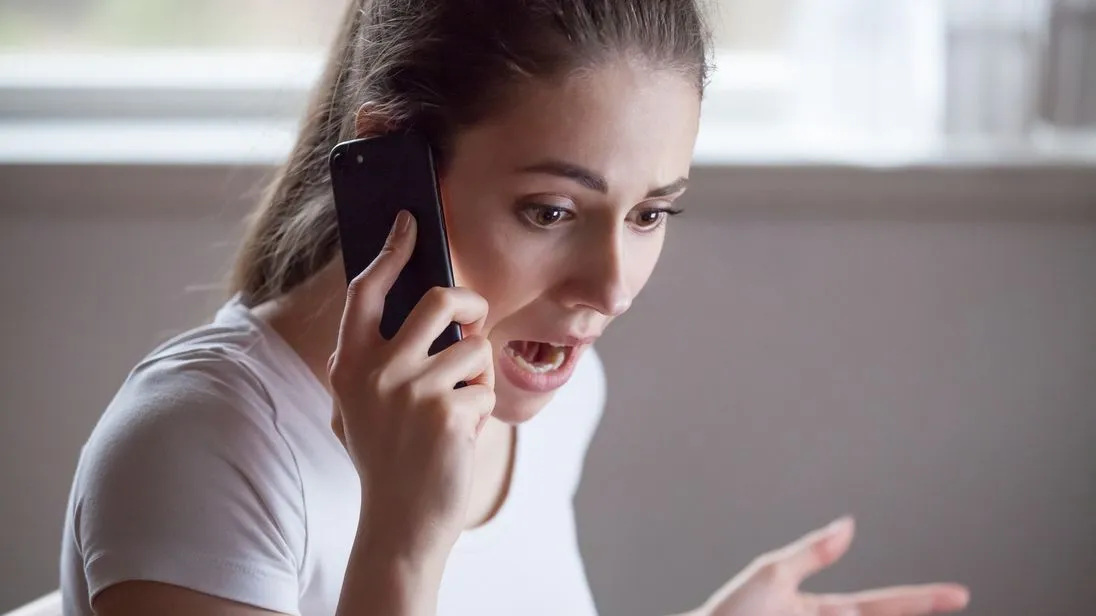 Close up of shocked woman hearing bad news over phone, scared female amazed by negative message received talking on cell, frustrated girl feeling devastated cannot believe horrifying information