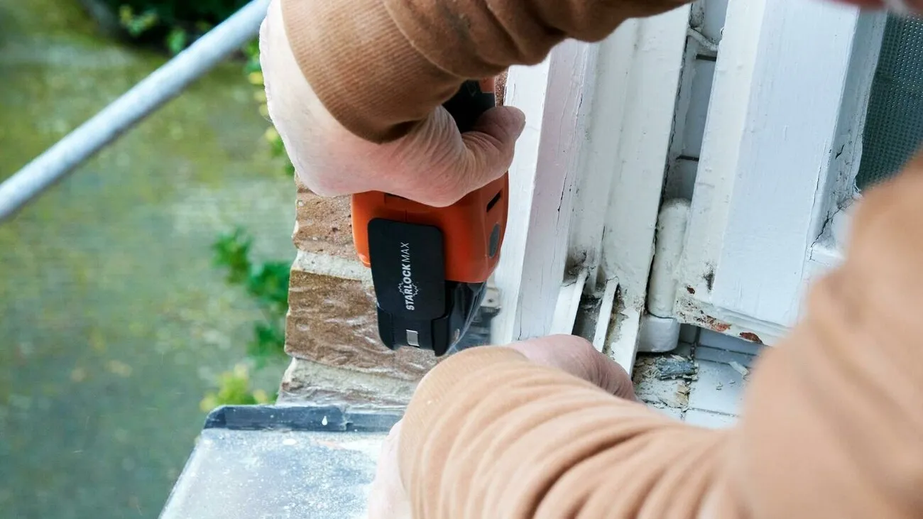 Ein Handwerker arbeitet mit dem Fein Multimaster 700 an einer Fensterbank.