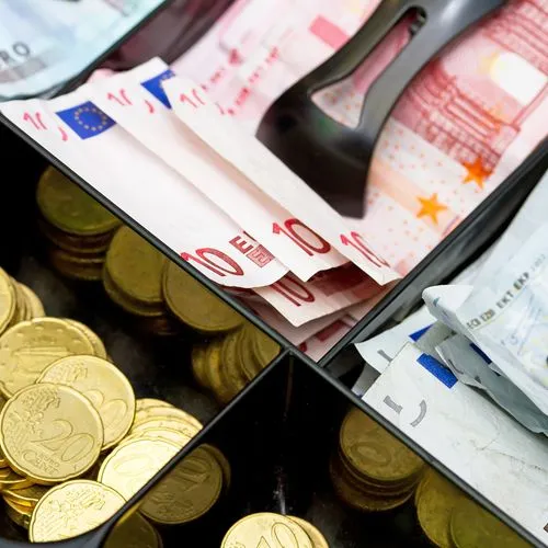 Kasse mit Euro-scheinen und Münzen