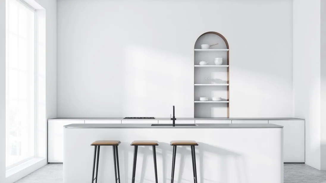 Interior of modern kitchen with white walls, concrete floor, arched cupboard, white countertops with built in cooker and white bar with stools. 3d rendering