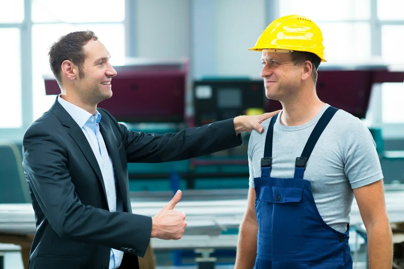 young boss is lauding worker in factory