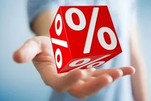 Businessman on blurred background using white and red sales flying icons 3D rendering