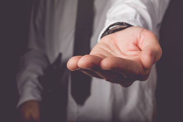 Businessman requesting for money loan, retro toned image, selective focus