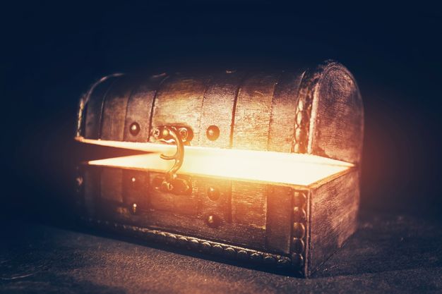 Magic wooden box with glowing light. Ancient mysterious chest. Precious antique box.